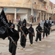 Fighters of al-Qaeda linked to the Islamic State of Iraq and the Levant carry their weapons during a parade at the Syrian town of Tel Abyad, near the border with Turkey in Jan. 2014.